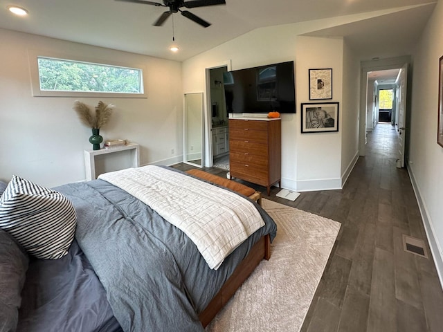 bedroom with ceiling fan, dark wood-type flooring, multiple windows, and ensuite bathroom