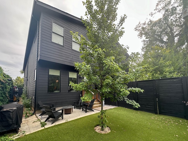 rear view of house with a patio area and a yard