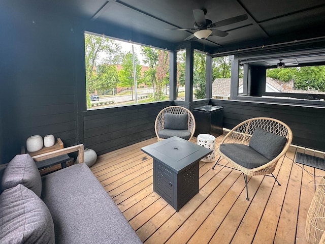 sunroom featuring ceiling fan and a healthy amount of sunlight