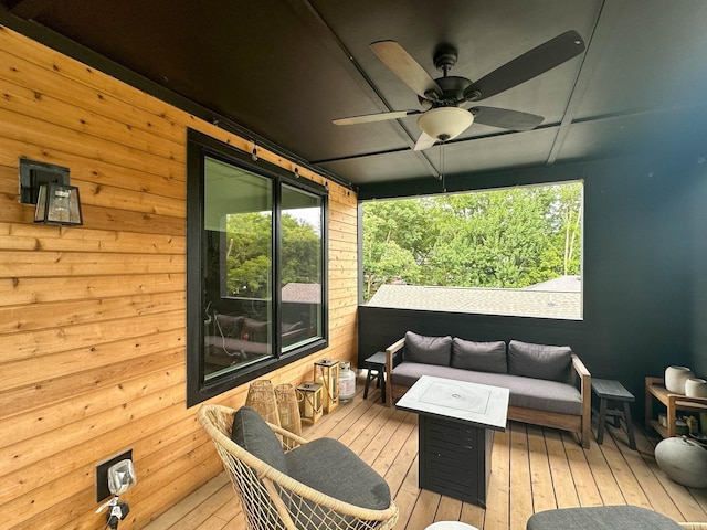 wooden deck with an outdoor hangout area and ceiling fan