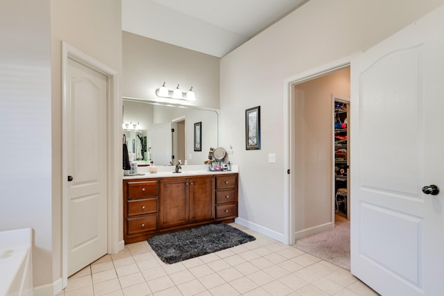 bathroom featuring a bathtub, tile patterned floors, and vanity