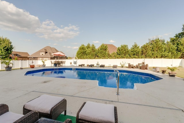 view of swimming pool with a patio