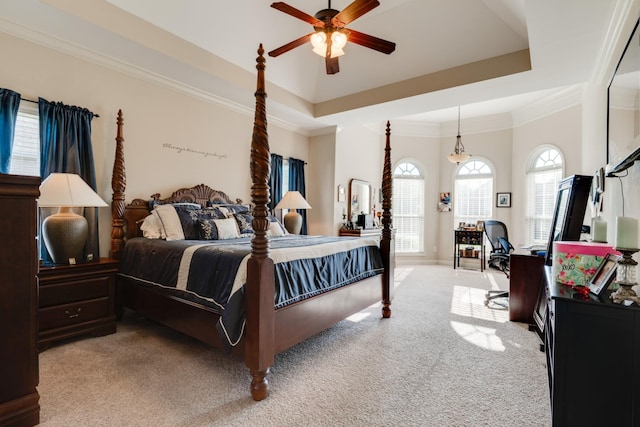 bedroom with ceiling fan, a raised ceiling, and light carpet