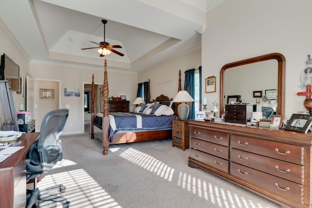 bedroom with light carpet, ornamental molding, ceiling fan, and a raised ceiling