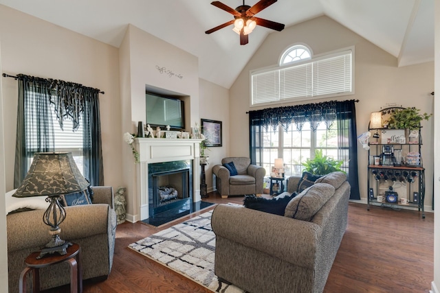 living room featuring a premium fireplace, ceiling fan, high vaulted ceiling, and dark hardwood / wood-style flooring