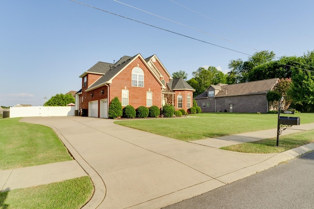 view of front of house with a garage and a front lawn