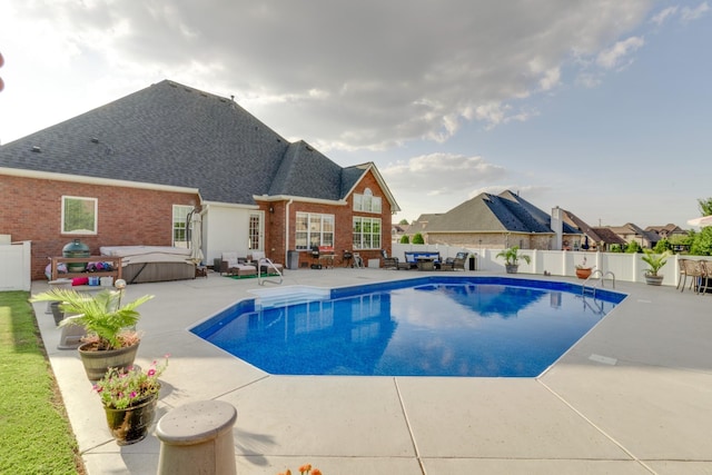 view of pool with a patio and a hot tub