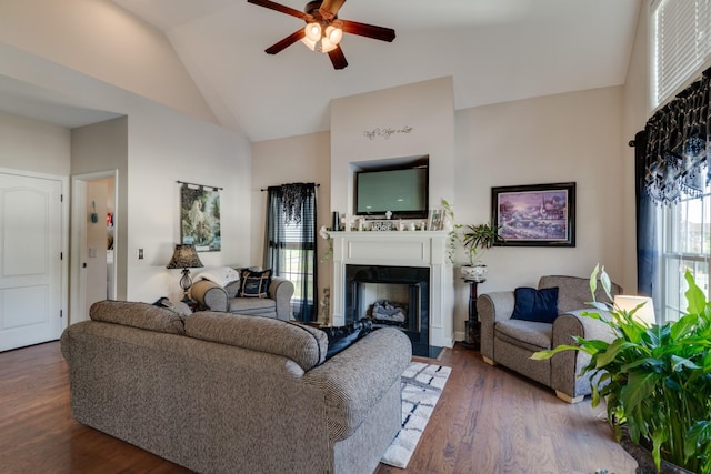 living room featuring ceiling fan, dark hardwood / wood-style flooring, and vaulted ceiling