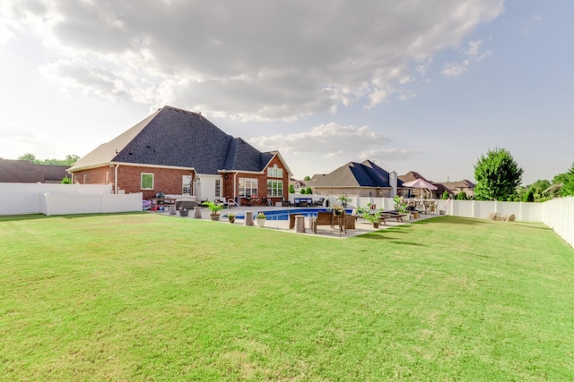 view of yard featuring a patio area and a fenced in pool