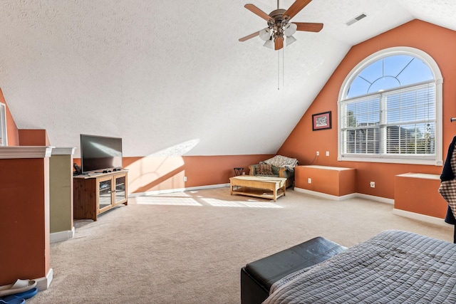 bedroom with ceiling fan, a textured ceiling, vaulted ceiling, and light carpet