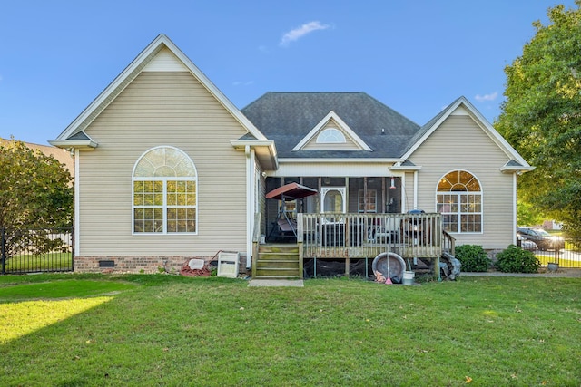 rear view of house with a wooden deck, a yard, and a sunroom