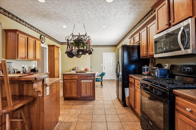 kitchen with crown molding, black appliances, a textured ceiling, and light tile patterned floors