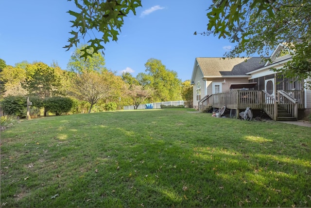 view of yard featuring a deck and a sunroom