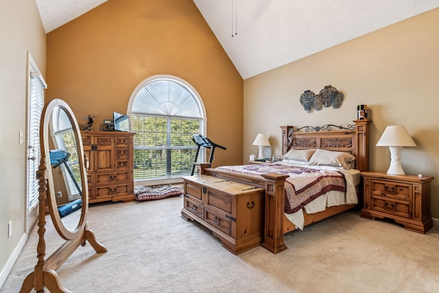 carpeted bedroom with high vaulted ceiling