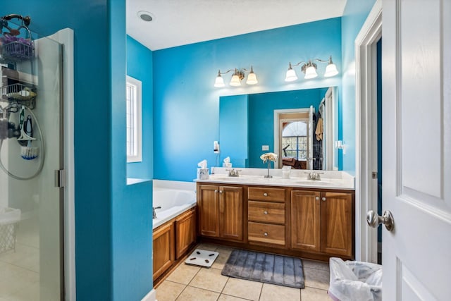 bathroom featuring vanity, shower with separate bathtub, and tile patterned floors