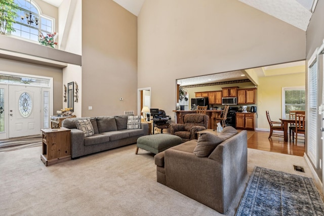 carpeted living room with a towering ceiling