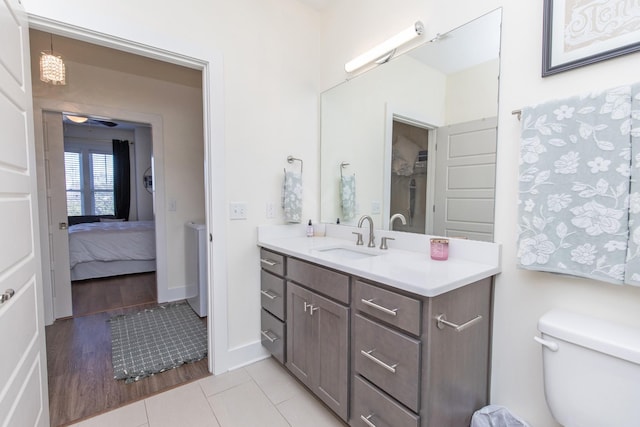 bathroom featuring vanity, toilet, and tile patterned flooring