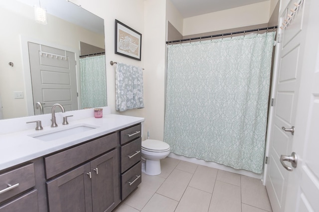 bathroom featuring toilet, tile patterned flooring, and vanity