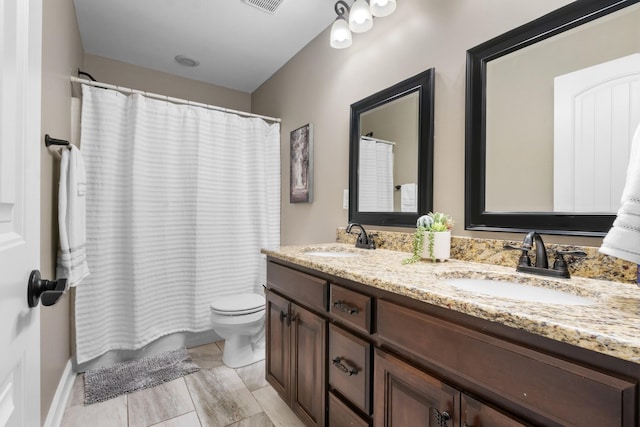 bathroom with toilet and vanity