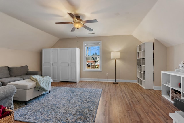 living room with vaulted ceiling, ceiling fan, and wood-type flooring