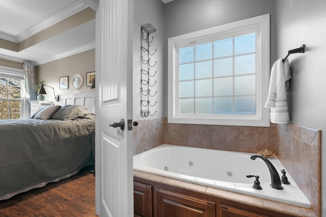 bathroom with hardwood / wood-style floors, a bathing tub, and ornamental molding