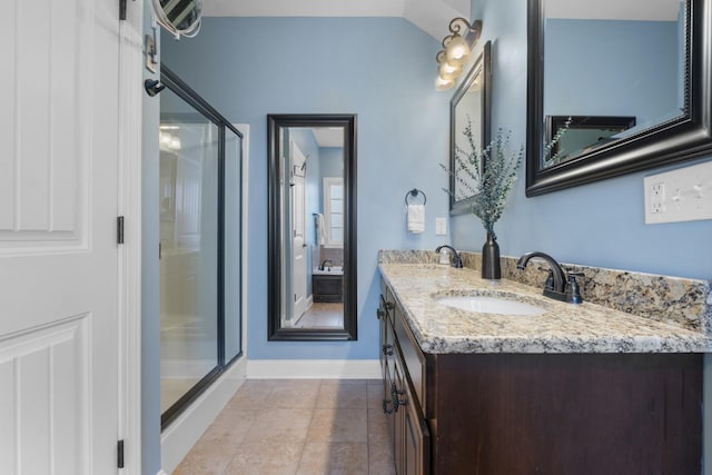 bathroom with vanity, an enclosed shower, and tile patterned flooring