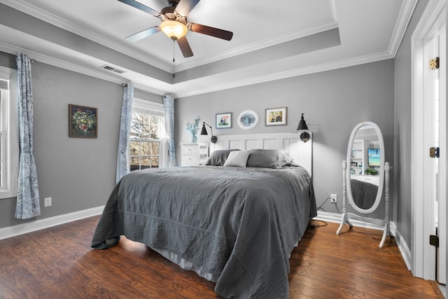 bedroom with crown molding, ceiling fan, and a raised ceiling