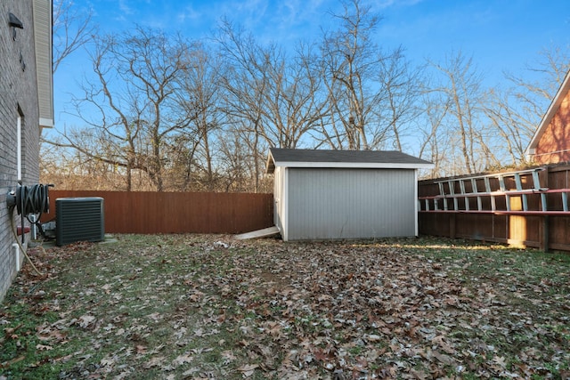 view of yard with a storage shed and central AC