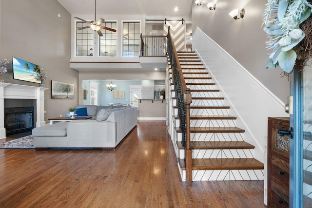 interior space featuring a tiled fireplace, hardwood / wood-style flooring, a wealth of natural light, and ceiling fan