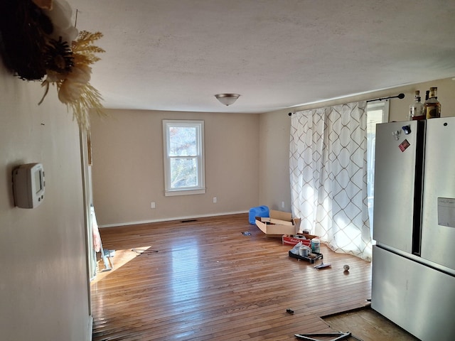 kitchen with light hardwood / wood-style flooring and fridge