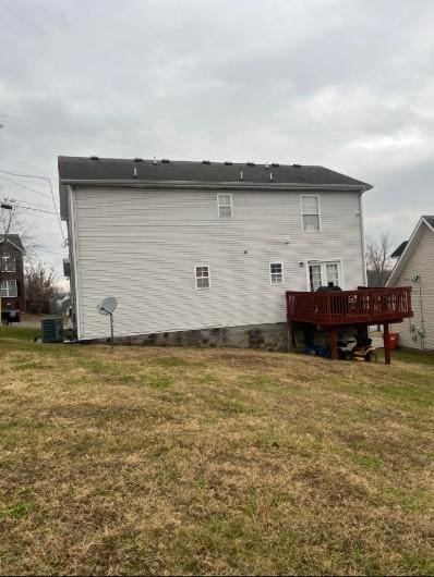 back of house featuring a wooden deck, central air condition unit, and a lawn