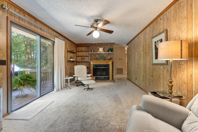 living room with carpet flooring, wooden walls, and a textured ceiling