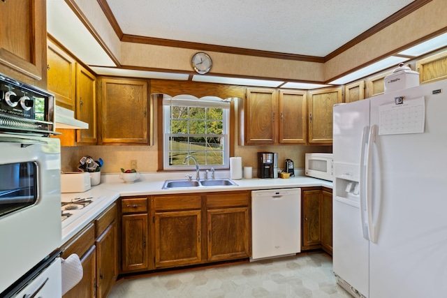 kitchen with sink, white appliances, and crown molding