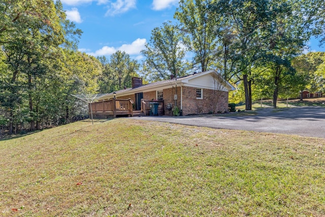 exterior space with a deck and a yard