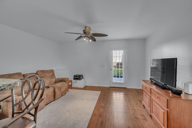 living room featuring ceiling fan and light hardwood / wood-style flooring