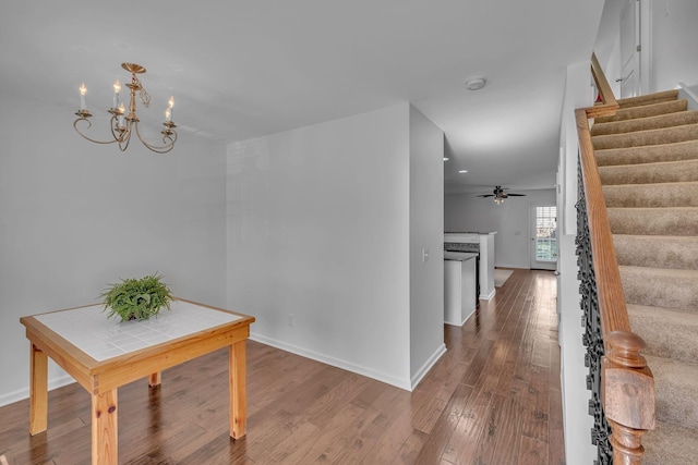 hall with hardwood / wood-style floors and a chandelier