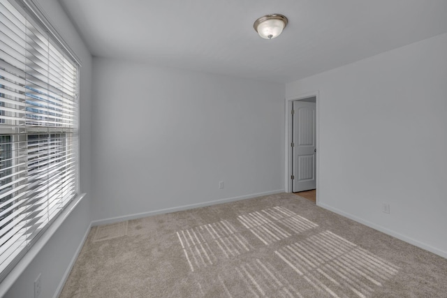 spare room with light colored carpet