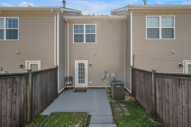 rear view of property with a patio area and central AC