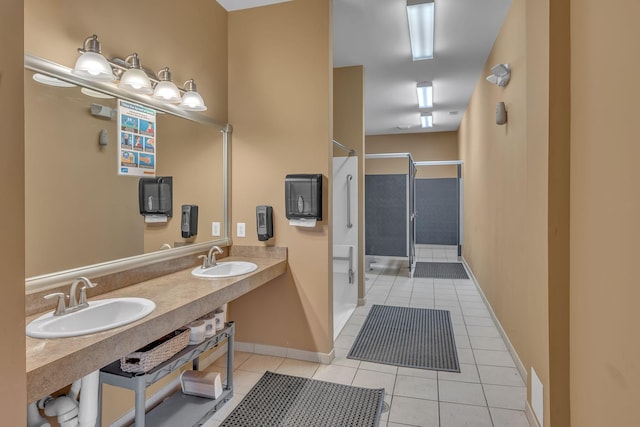 bathroom featuring dual sinks, tile patterned floors, and a shower with door