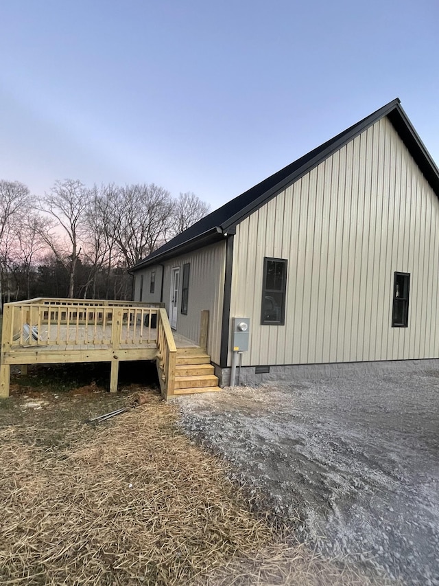 property exterior at dusk with a wooden deck