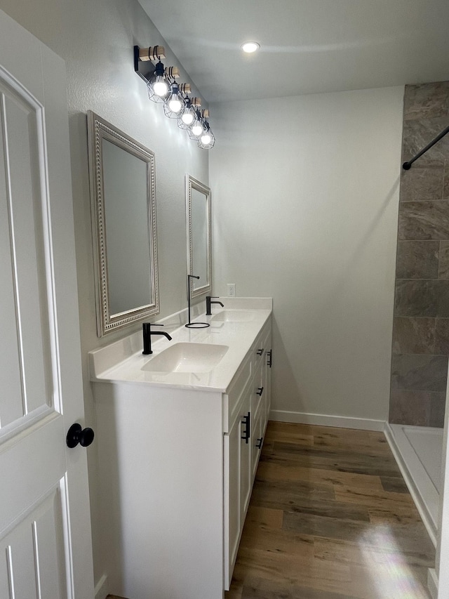 bathroom with vanity, hardwood / wood-style flooring, and walk in shower