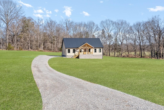 view of front of home with a front yard and covered porch