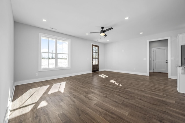 spare room with ceiling fan and dark wood-type flooring