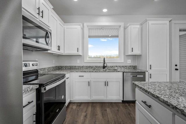 kitchen featuring light stone countertops, sink, white cabinets, and appliances with stainless steel finishes