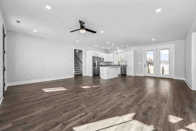 unfurnished living room with ceiling fan and dark hardwood / wood-style floors