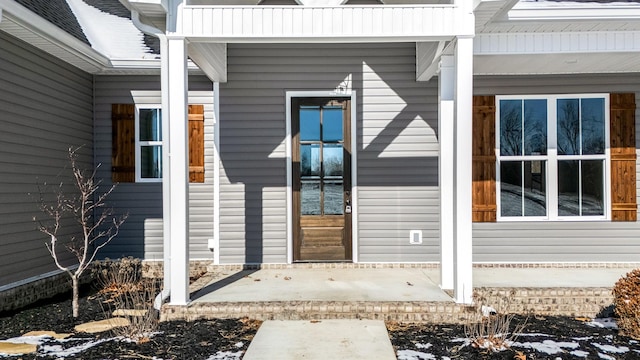 view of snow covered property entrance