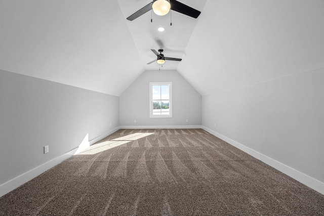 additional living space with vaulted ceiling, ceiling fan, and light colored carpet