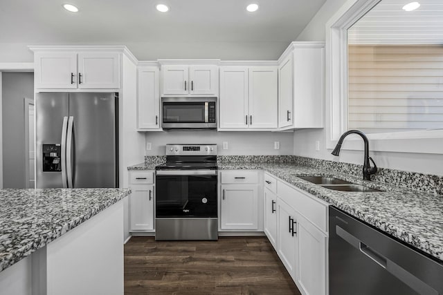 kitchen featuring sink, dark hardwood / wood-style flooring, white cabinetry, and stainless steel appliances