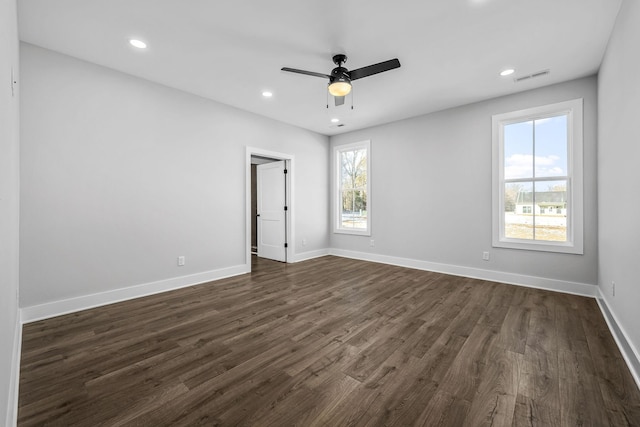 unfurnished bedroom featuring ceiling fan, dark hardwood / wood-style floors, and multiple windows