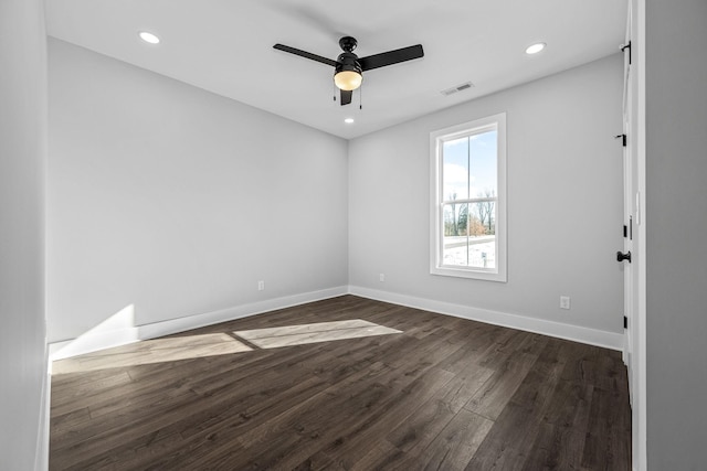 unfurnished room featuring ceiling fan and dark wood-type flooring